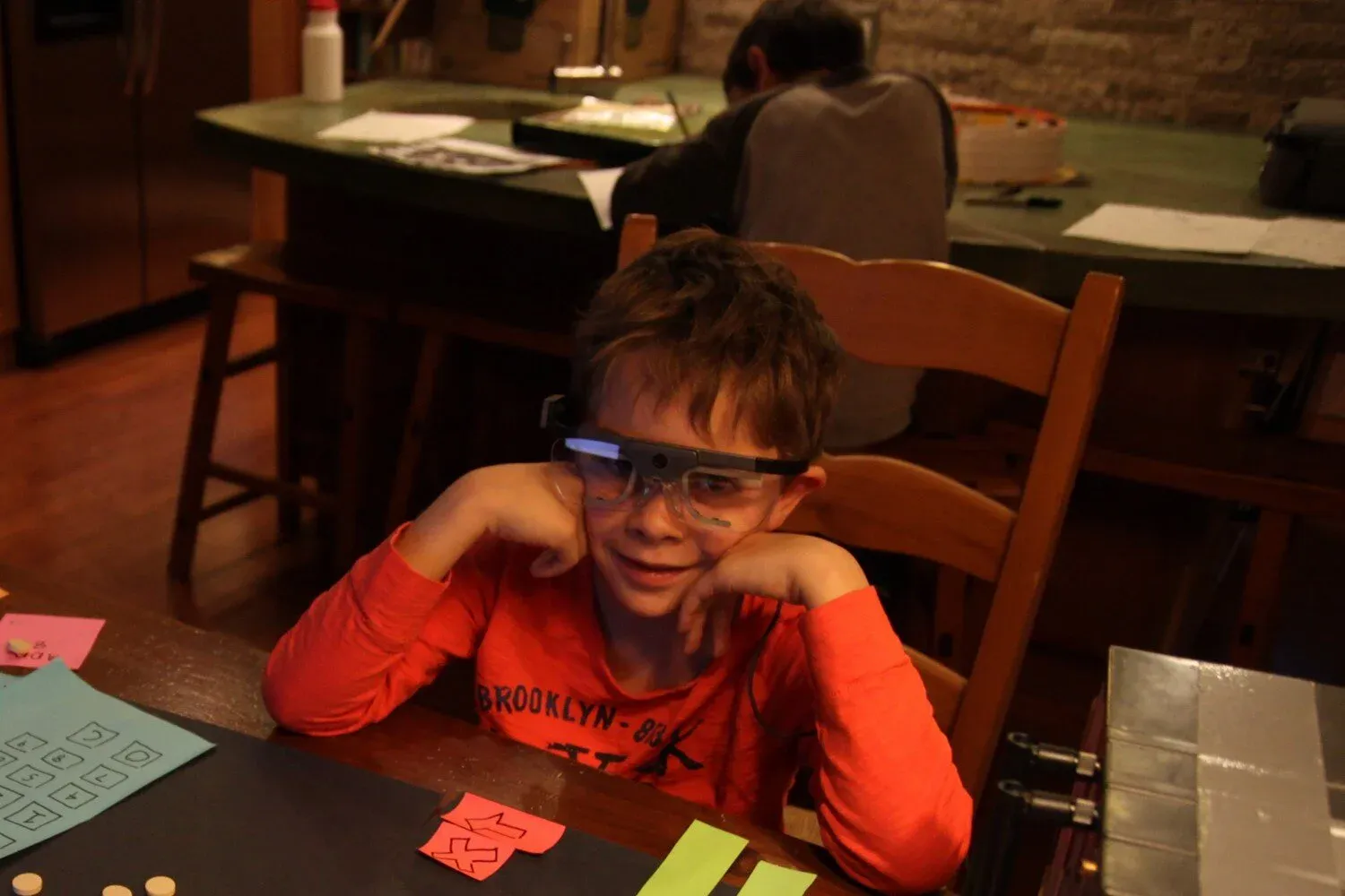 Child using digital math prototype while researcher observes