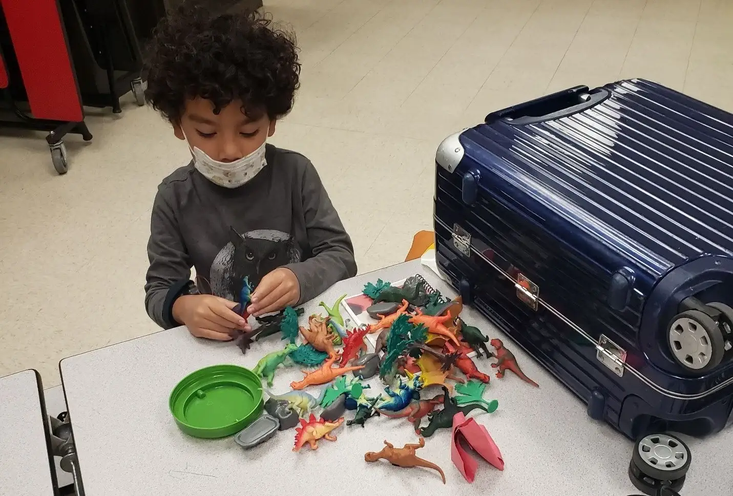 Student playing with dinosaurs during a prototype test session