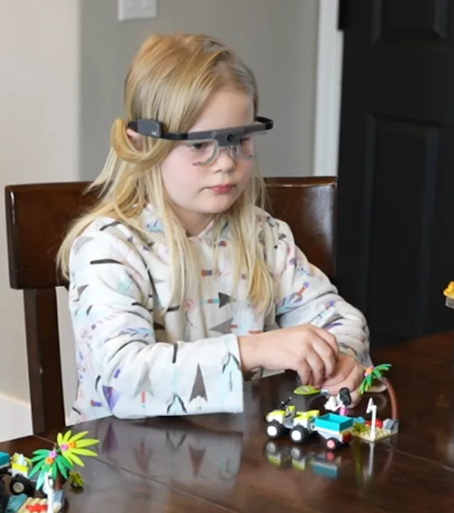 Student wearing eye-tracking glasses during the Escape the Volcano prototype test