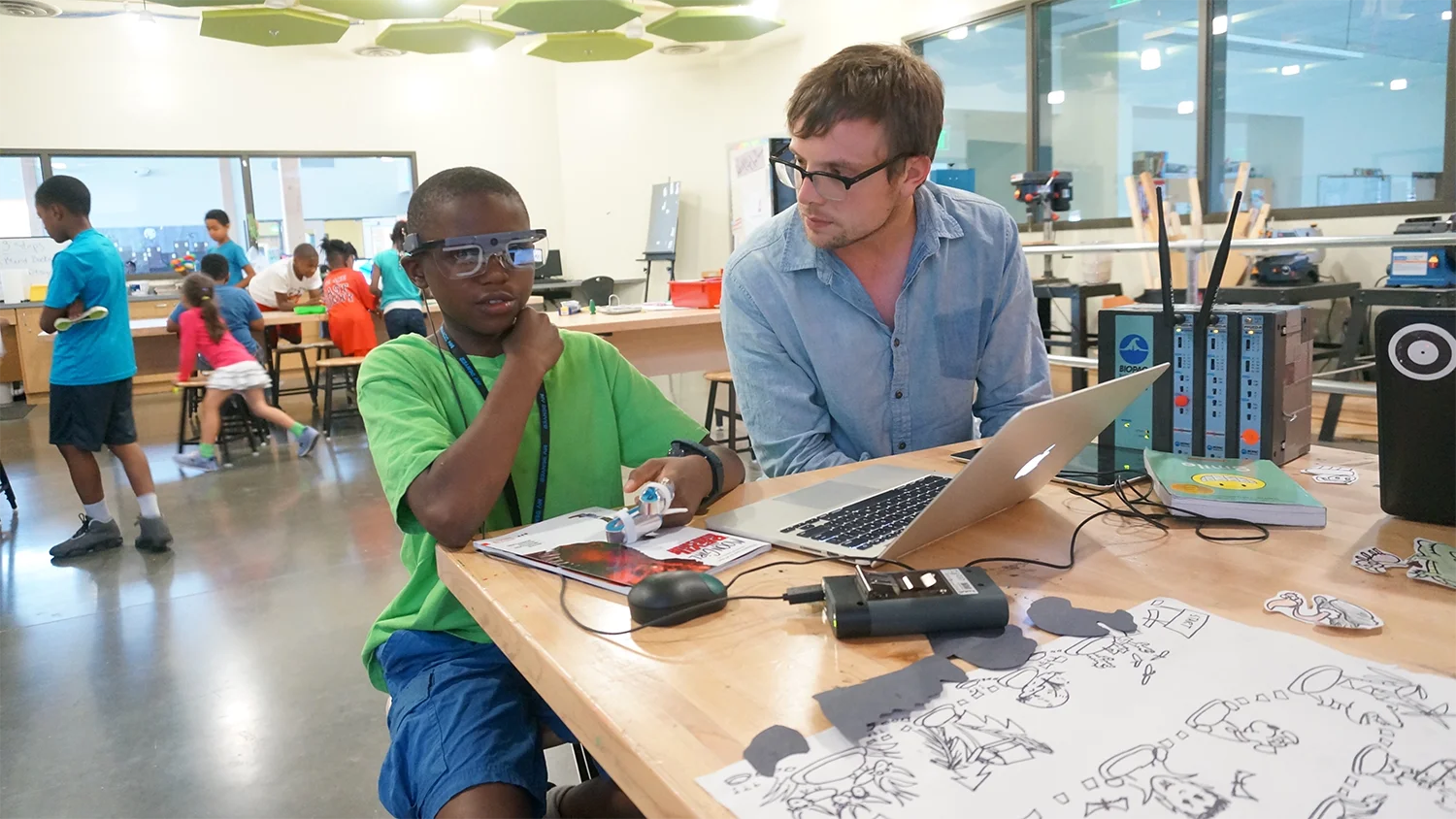 Student wearing eye-tracking glasses at a laptop during a Wonder.io research session